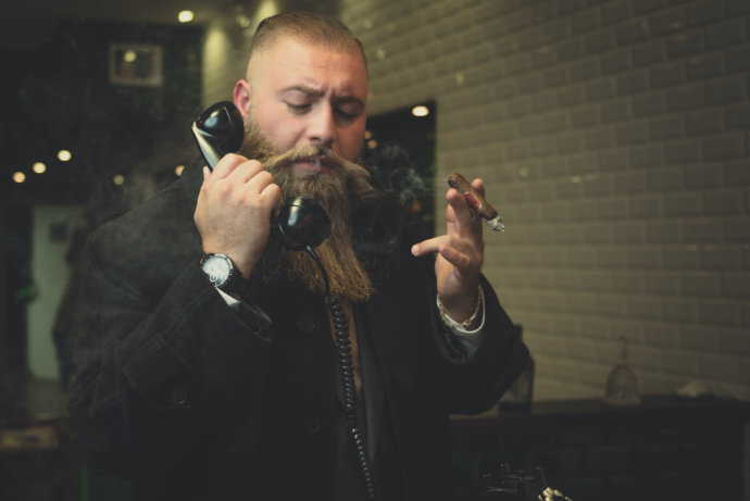 Location in Hagis Barbershop. Zu sehen ist ein Bart Model mit Analog Telefon in der Hand © Copyright UK Photographie